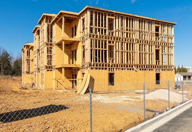 a close-up of temporary chain link fences enclosing a construction site, signaling progress in the project's development in Carmichael